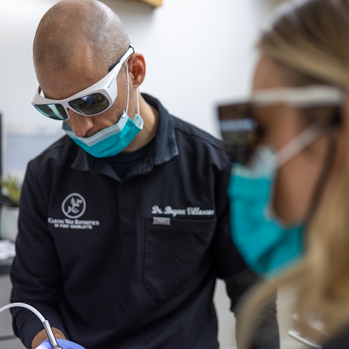 Doctor V and an assistant performing a procedure on a patient