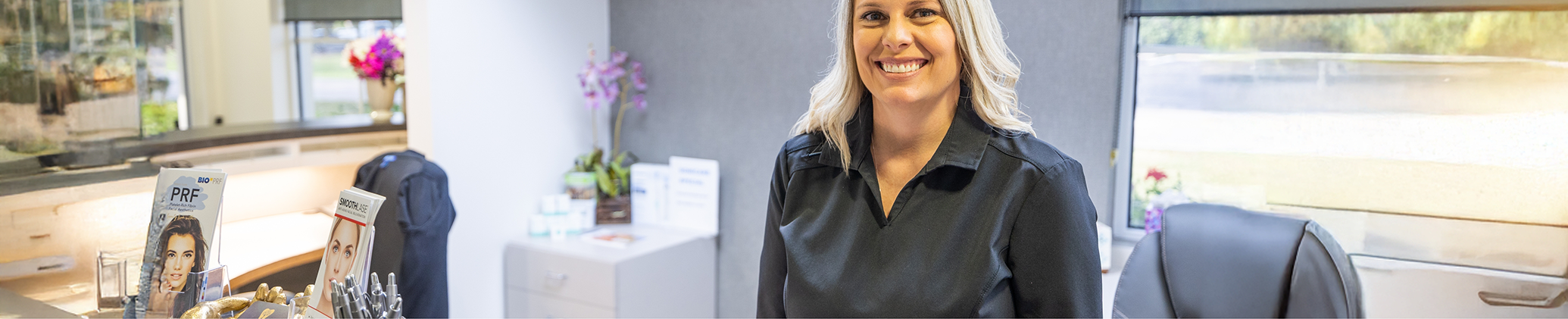 Caring Way Esthetics of Port Charlotte team member smiling at front desk