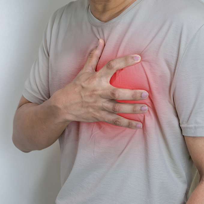 Person clutching their heart in pain