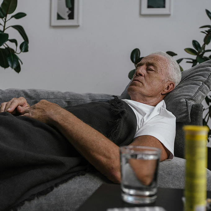 Senior man sleeping on a couch