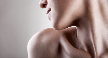 Close up of a young person with smooth skin on their neck and shoulders
