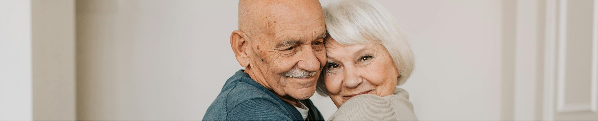 Senior couple hugging and smiling after treatment with platelet rich fibrin