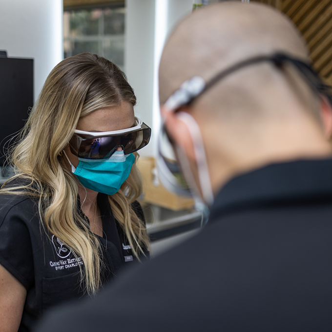 Doctor V and an assistant performing a procedure on a patient
