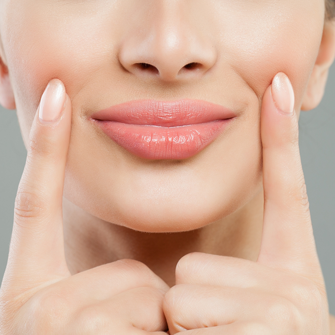 Close up of a smiling woman with full lips