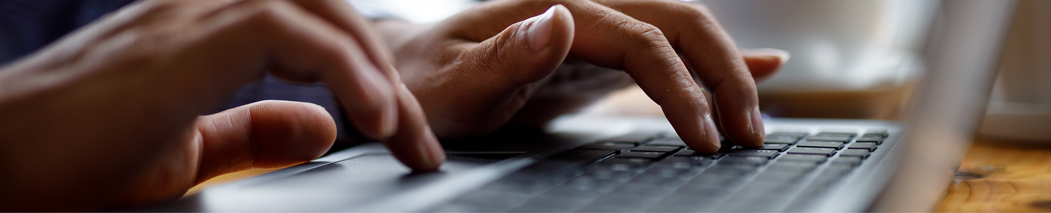 Person typing on a keyboard
