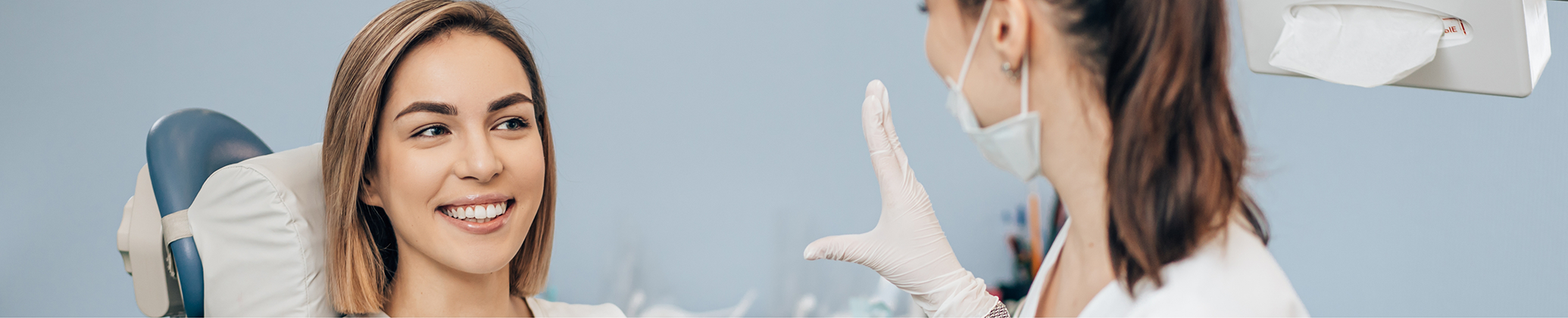 Woman smiling while talking to her esthetic dentist