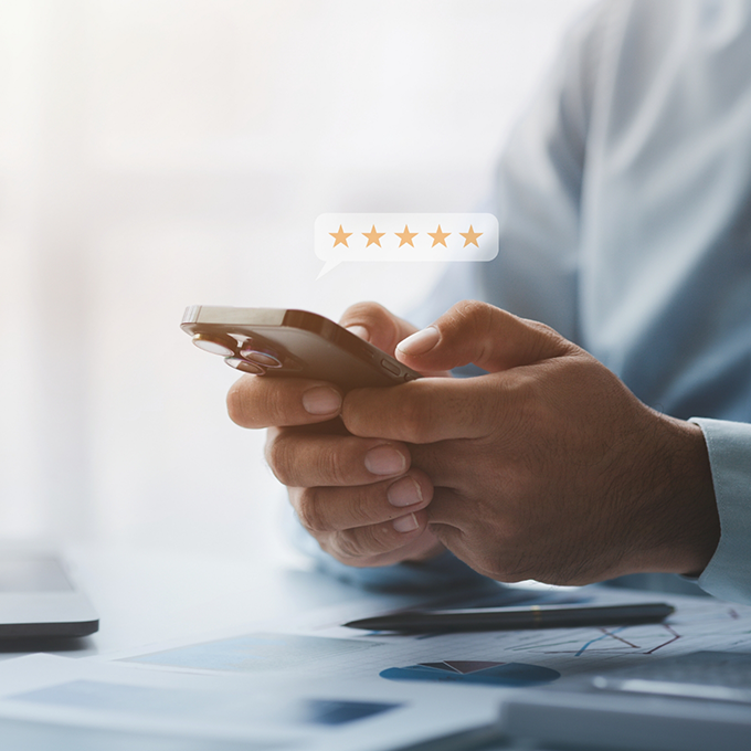 Person typing a five star review on their phone