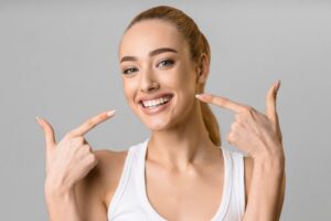 Woman smiling after final veneer placement